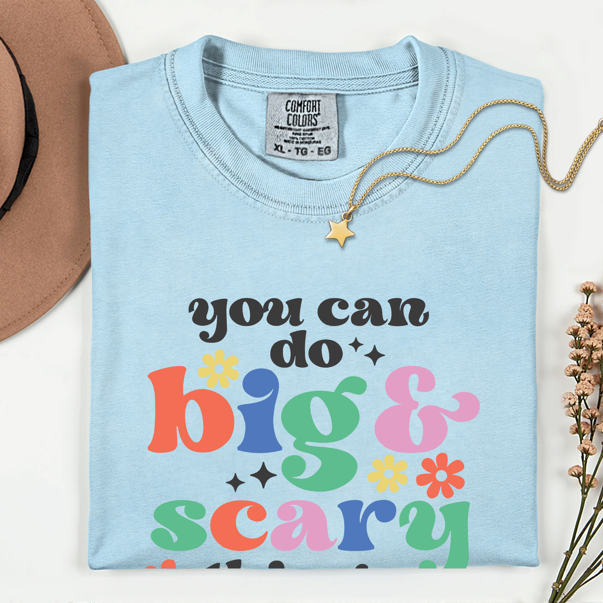 Light blue t-shirt with colorful text 'you can do big & scary' on a white background